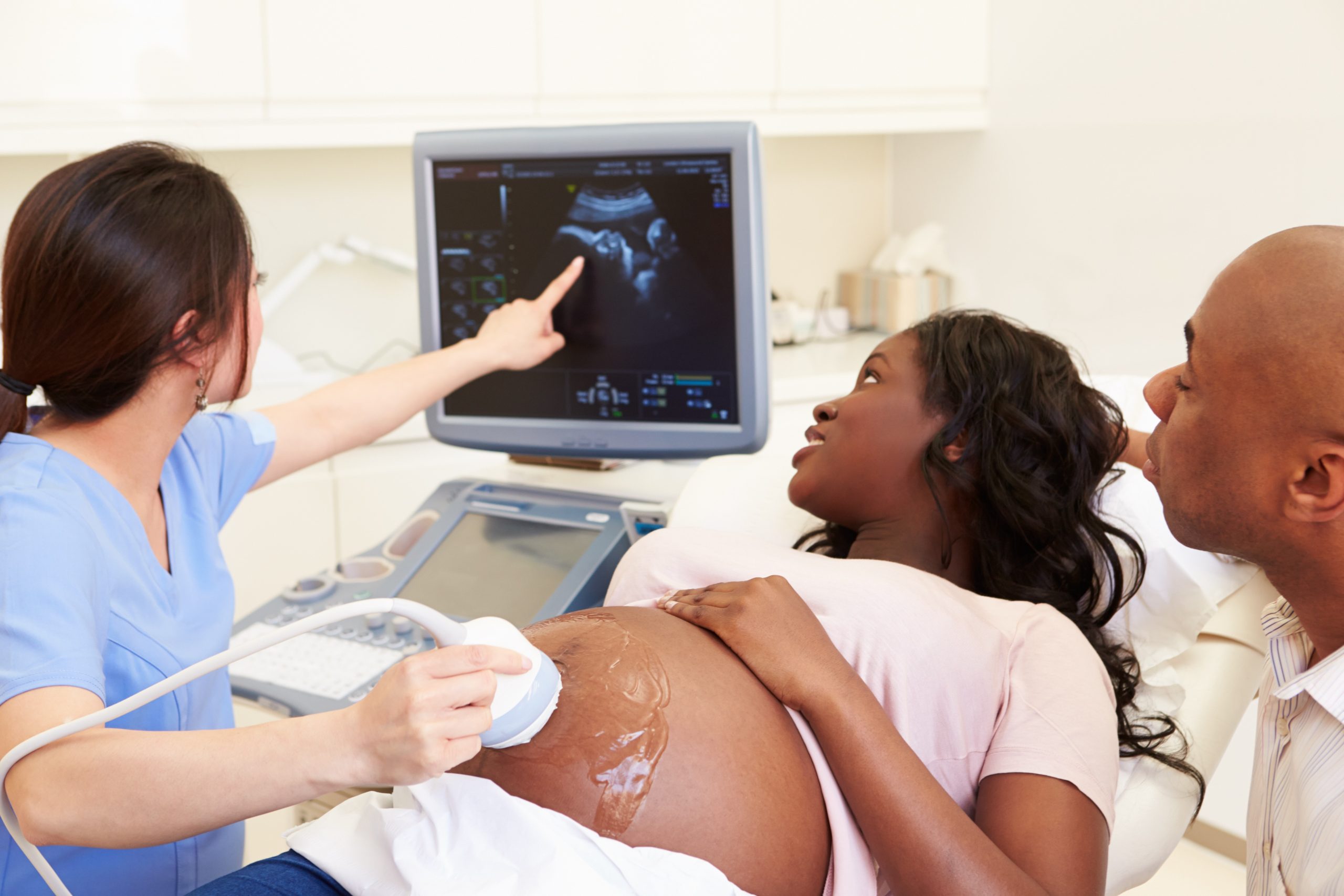 Layed Down Pregnant Woman And Partner Having 4D Ultrasound Scan
